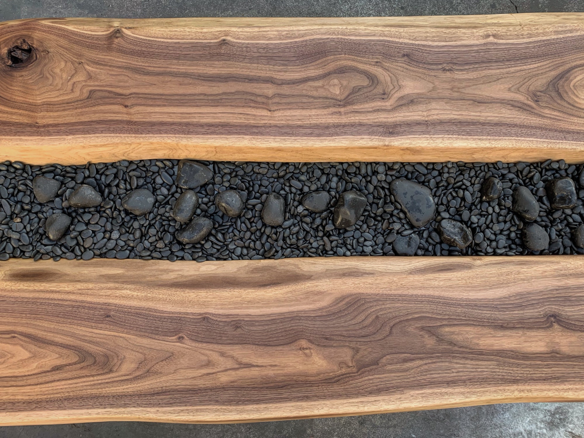 Walnut wood slabs and river rocks